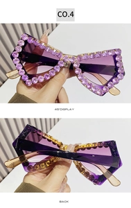 Detail view of butterfly frame sunglasses with purple rhinestones and thick temples