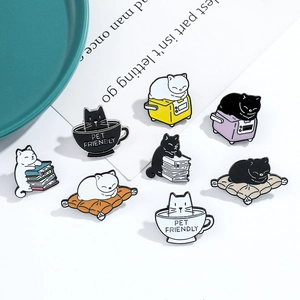 Detailed set of 8 cartoon cat enamel pins showing black and white cats with books and coffee