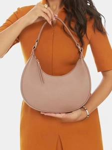 Detail view of stylish half moon bag in pastel leather with tassel zipper and silver rings