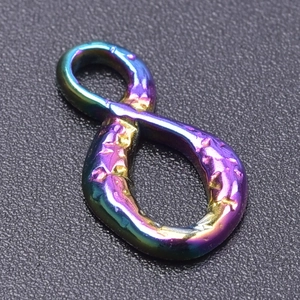 Macro shot of 8-shaped 304 stainless steel DIY connector with rainbow finish and hammered texture