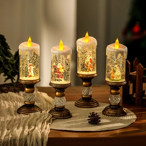 Detailed view of four Christmas LED water candles with Santa and glitter snow globe effects