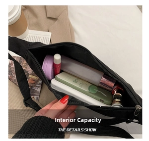 Internal storage detail of black nylon crossbody bag showing daily essentials capacity