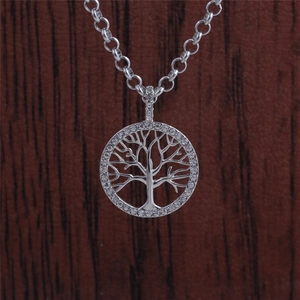 Silver titanium steel tree of life necklace with clear crystal rhinestones on wood background