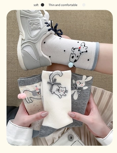 Close-up of soft cotton mid-calf socks with cute cartoon animal embroidery and bow details