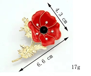 Detail view of red poppy flower brooch with enamel finish and crystal center petals