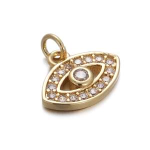 Macro shot of gold-plated evil eye pendant with zircon stones and blue enamel details