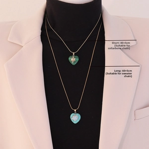 Detail view of heart-shaped natural stone pendants with gold star and evil eye motifs