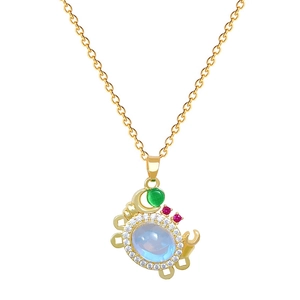 Luxurious gold crab necklace with moonstone and colorful diamonds on white background