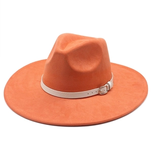 Macro detail of orange wide brim fedora hat with white leather band and metal buckle