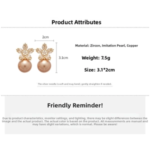 Detailed view of floral pearl earrings with zircon stones and champagne faux pearls
