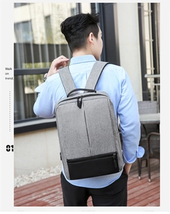 Rear view of a grey and black business laptop backpack on male model for daily commute