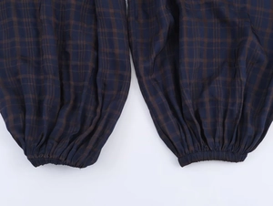 Detail view of elastic cuff on dark blue and brown checkered puff pants for women
