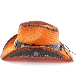 Close-up of orange straw cowboy hat with embossed brown leather band and silver studs