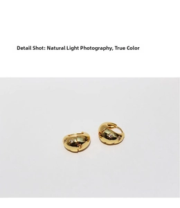 Detailed macro view of golden star engraved hoop earrings with micro-inlaid zircon crystals
