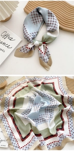 Detail of a 70cm silk scarf with light blue, sage green and red checkered patterns