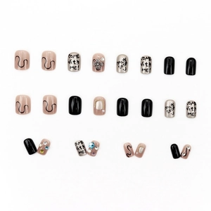 Y2K punk style press-on nails set with silver 3D charms and graffiti on white background