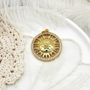 Golden sun face pendant necklace with tiny crystals on soft white feathers and lace