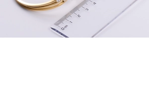 Close-up of gold-plated bangle showing the width measurement of approximately 0.7cm