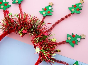 Détail d'un serre-tête de Noël avec des sapins verts scintillants et des sequins étoiles