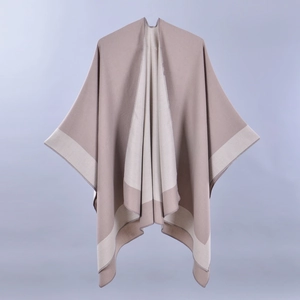 Detail of beige and tan split knit shawl showing soft cashmere-like texture and drape