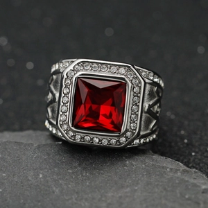 Macro view of men's stainless steel Masonic ring with square red gemstone and small diamonds