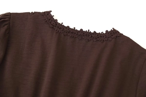 Detail des V-Ausschnitts mit Hohlsaum-Spitzenbesatz am dunkelbraunen Langarmkleid
