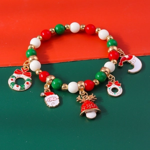 Detail of Christmas beaded bracelet with Santa Claus and reindeer alloy charms