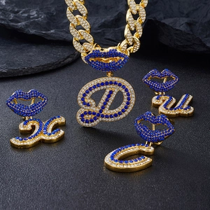 Macro detail of gold-plated D-letter and blue lip pendant set with sparkling rhinestones
