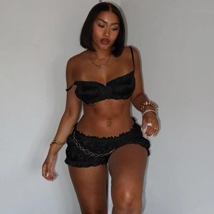Chic black two-piece summer set with pleated tube top and chain detail shorts