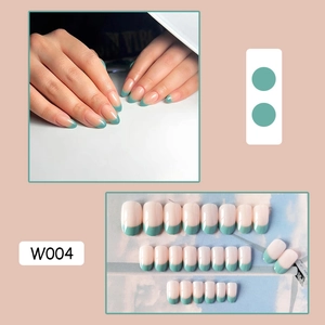 Detail of French press-on nails in nude pink and teal green tips with full set layout