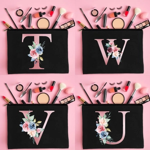 Minimalist black canvas cosmetic bag with rose gold floral letters and zipper closure