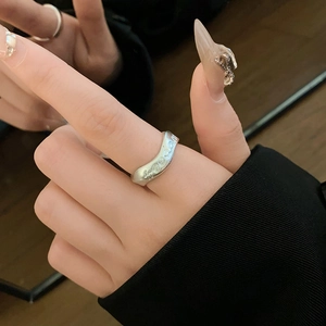 Detailed view of silver wave ring featuring embossed freedom lettering in a trendy style
