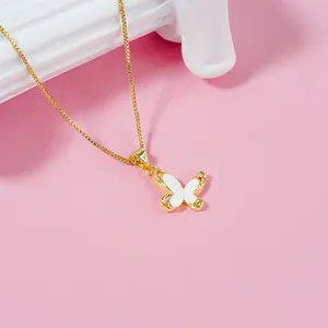Gold butterfly pendant necklace with white enamel inlay and zircon on a box chain