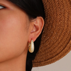 French vintage style gold teardrop earrings with pave zircons worn by a model