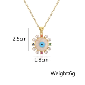 Detail showing 18K gold evil eye pendant dimensions 1.8cm and 6g weight on white backdrop