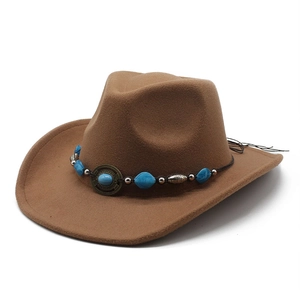 Detail of a brown felt cowboy hat featuring a turquoise beaded band and vintage metal buckle