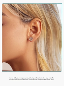 Close-up of elegant S925 sterling silver Celtic knot stud earrings worn by a model