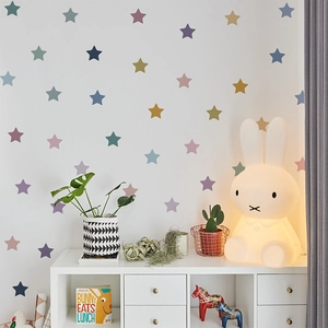 Colorful star wall decals displayed in a cozy bedroom with Miffy lamp and plants decor