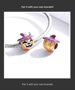 Macro view of Halloween pumpkin charms with purple wizard hat on a silver bracelet