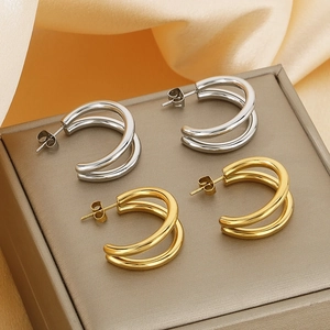Minimalist double layer hoop earrings in gold and silver finish on a silk jewelry box