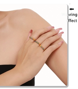 Detailed view of three 18K gold plated rings set with vibrant multi-colored zircons