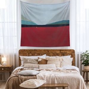 Abstract landscape wall tapestry showing a warm red horizon and blue sky in bedroom