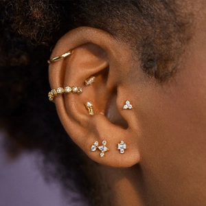 Close-up of S925 sterling silver gold ear cuff and stud set with clear crystals on ear