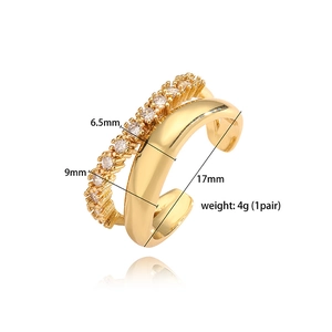 Macro detail of V-shaped gold ear cuff with white zircon inlay and polished double band layer