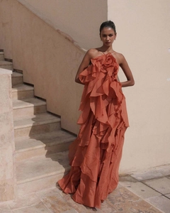 Detail of a brick red multi-layered ruffled dress with an elegant backless halter neck