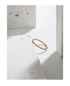 Macro shot of minimalist rose gold S925 sterling silver ring with cubic zirconia inlay