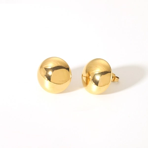 Detail of minimalist 18K gold-plated stainless steel spherical stud earrings on white background
