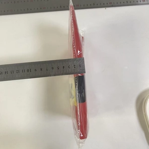 Detail shot of the 2cm thickness measurement of the festive red Christmas home apron