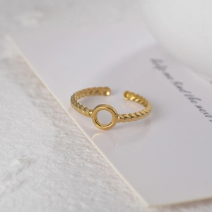 Detail of 14K gold plated titanium steel twisted rope ring with hollow round center