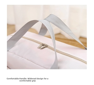 Detail of the widened nylon handle and durable metal zippers on a large travel bag
